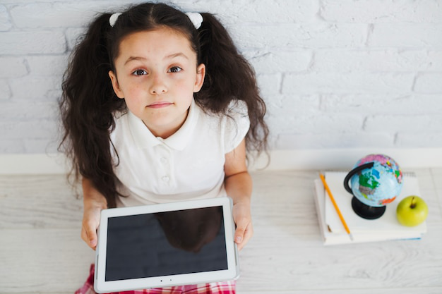 a girl holding a tablet