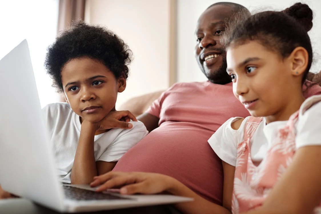 a family using a laptop