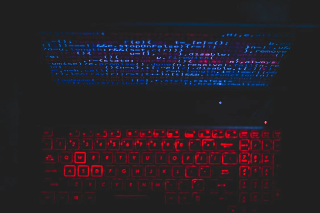 Blue and red lights emanating from a computer, representing coding for cybersecurity,